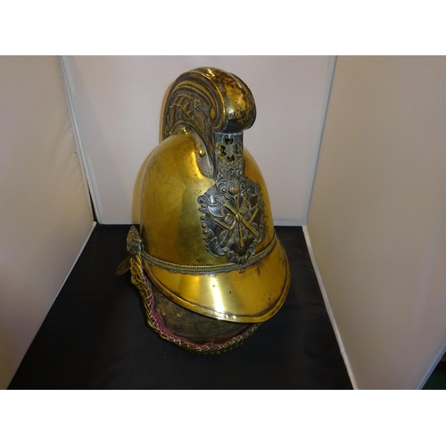 18 - A good original Fireman's brass helmet, with chin chain, badge, rosettes, and leather lining. GC £20... 