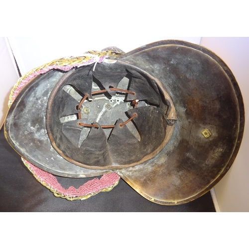 18 - A good original Fireman's brass helmet, with chin chain, badge, rosettes, and leather lining. GC £20... 