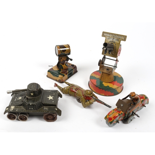 389 - 5 Military related tinplate toys. Sparking gun (made in England), on a circular base with rotate and... 