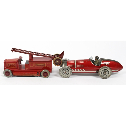 394 - A LOUIS MARX stream lined tin plate wind up racing car in red with driver and No.410 to rear fin. Re... 