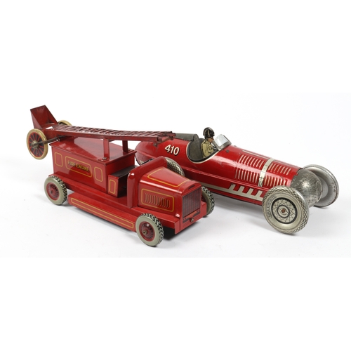 394 - A LOUIS MARX stream lined tin plate wind up racing car in red with driver and No.410 to rear fin. Re... 