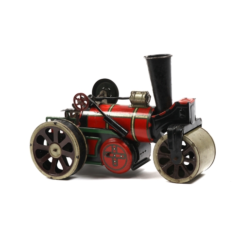 396 - A possibly German produced tinplate road roller, finished in red and green, has a clock work motor t... 