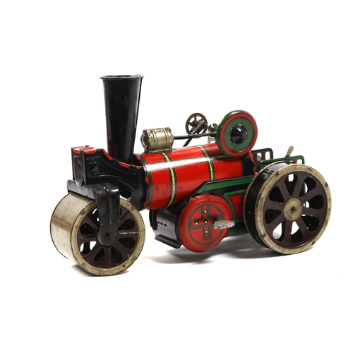 396 - A possibly German produced tinplate road roller, finished in red and green, has a clock work motor t... 