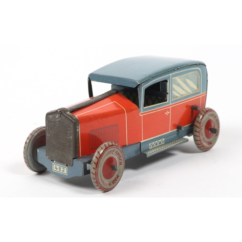 405 - A very scarce 1920s  Tinplate saloon car made in Germany by MARKE STOCK, finished in lined red litho... 