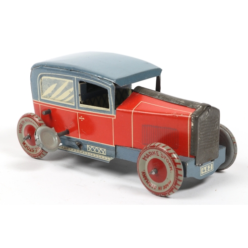 405 - A very scarce 1920s  Tinplate saloon car made in Germany by MARKE STOCK, finished in lined red litho... 