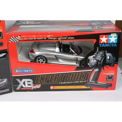 267 - 2x Tamiya 1:10 scale sports/racing cars. Porsche Carrera G.T. . In silver, plus a Mercedes-Benz C-Cl... 