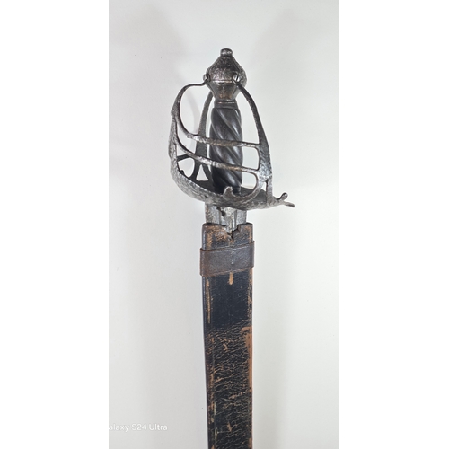 643 - A basket hilted Mortuary' broadsword c. 1650-60, broad double edge blade 82cms cut with a pair of sh... 