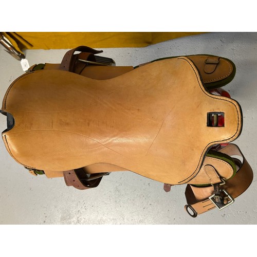 239 - A leather saddle with prominent iron frame, leather stencilled JCCO 1988 429 5127 TS, nickel stirrup... 