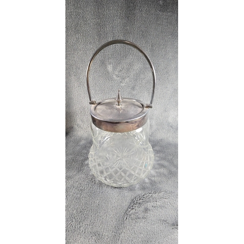 54 - A cut glass biscuit barrel with EPNS mounts, 14cms tall, folding handle, lid with stepped Knob. Good... 