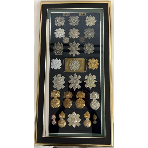 221 - An attractively framed display of 28 mostly restrike Scottish badges, glengarries, 2 collars, 2 titl... 