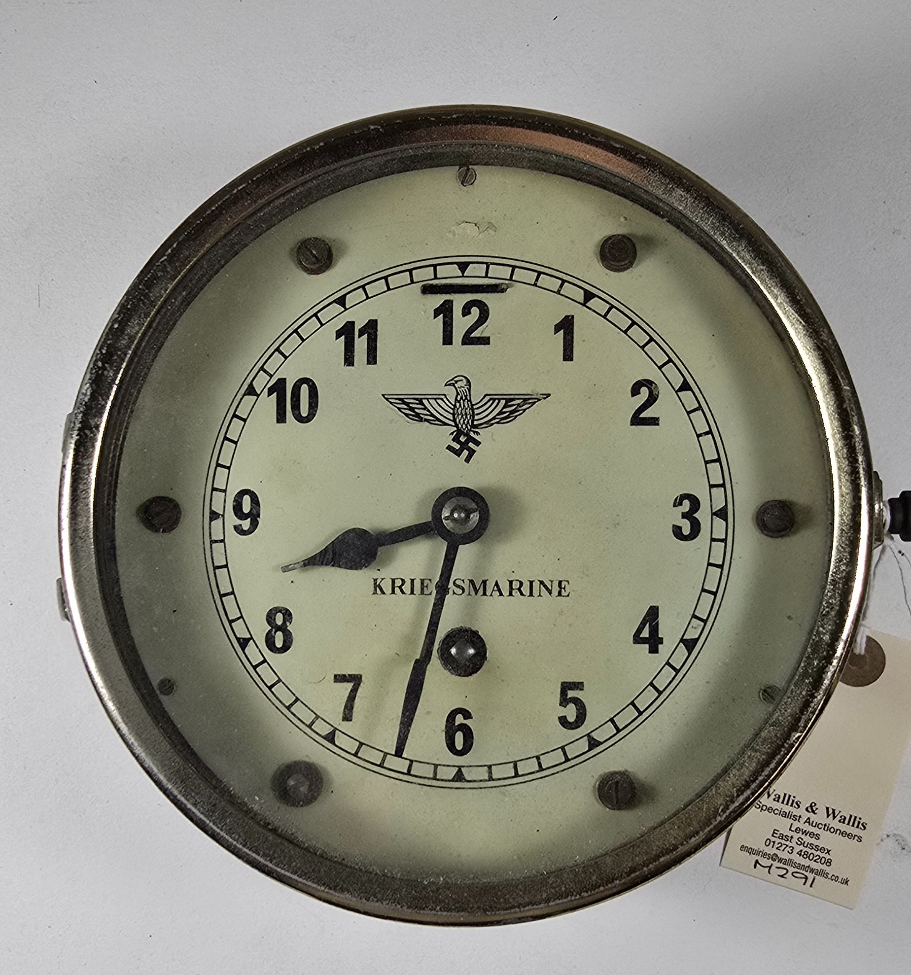A WWII period German ship's brass bulkhead clock, the white dial ...