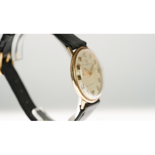 47 - Omega Geneve manual wind wristwatch in gold. 33.5mm. White dial has some staining. Omega signed buck... 
