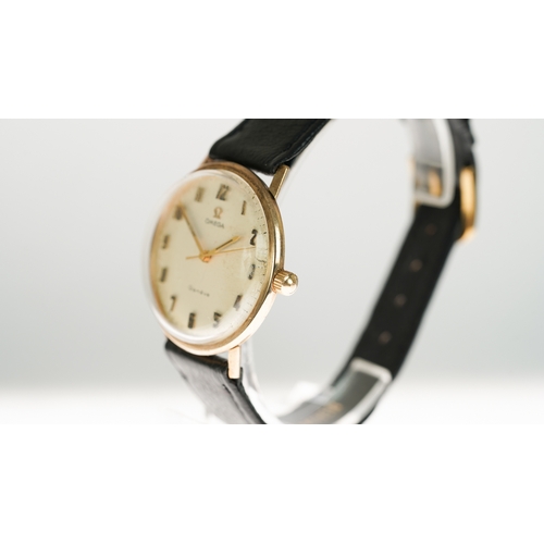 47 - Omega Geneve manual wind wristwatch in gold. 33.5mm. White dial has some staining. Omega signed buck... 
