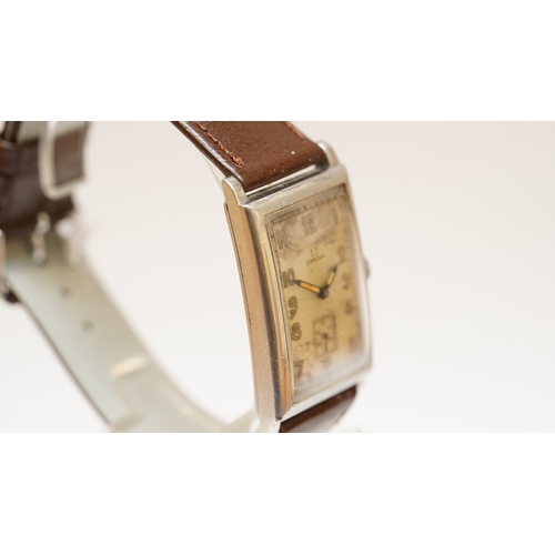 11 - Omega Tank watch in steel, c.1920s-30s. 25mmx42mm. Silvered dial with sub seconds register, luminous... 