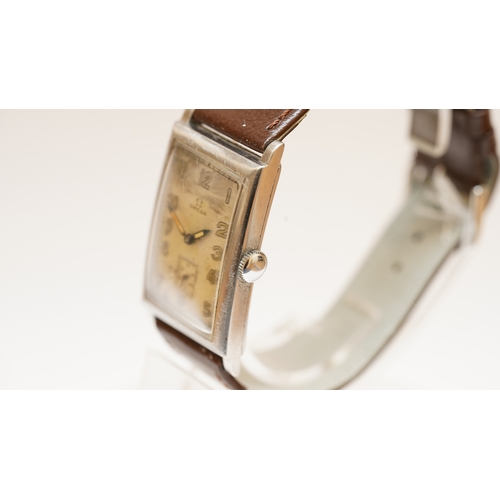 11 - Omega Tank watch in steel, c.1920s-30s. 25mmx42mm. Silvered dial with sub seconds register, luminous... 
