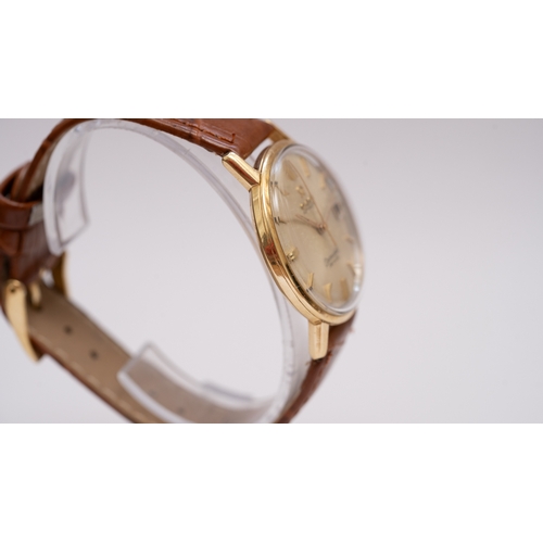 57 - Omega Seamaster Deville date in gold. 34.5mm. Silver dial with gold indices, some spotting. Automati... 