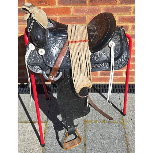 357 - A Mexican black leather saddle, the leather tooled overall with foliage in traditional patterns, lam... 