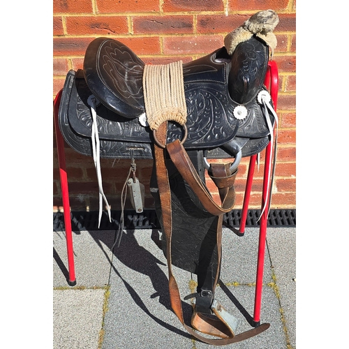 357 - A Mexican black leather saddle, the leather tooled overall with foliage in traditional patterns, lam... 