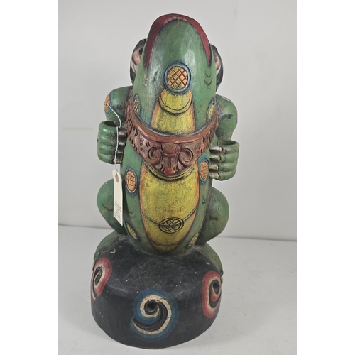 372 - An attractive 20th century Balinese carved wooden kris stand in the form of a standing frog, painted... 