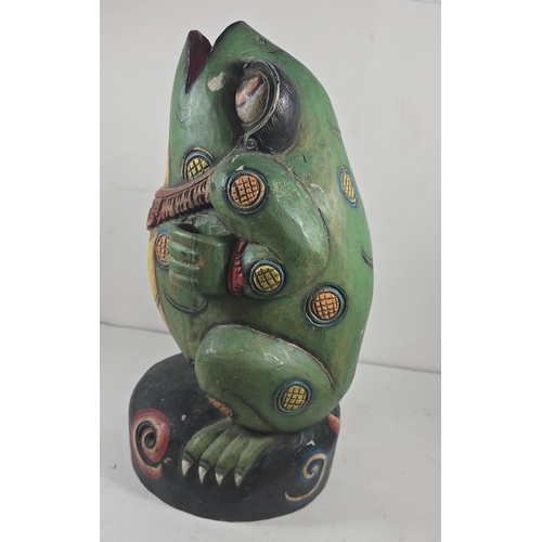 372 - An attractive 20th century Balinese carved wooden kris stand in the form of a standing frog, painted... 