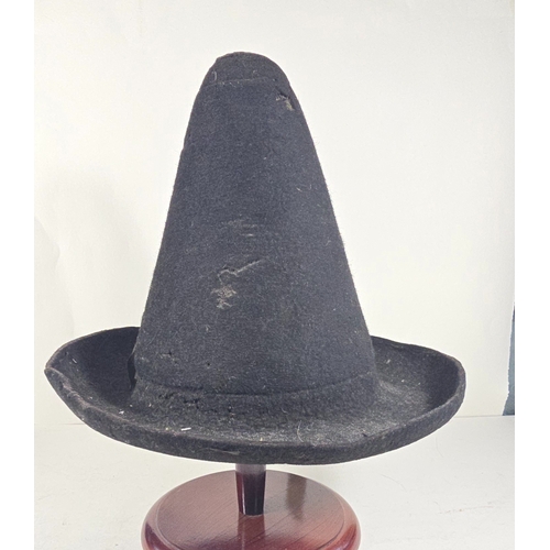 418 - An early (18thcentury?) black felt hat, with conical skull, upturned brim and remains of silk facing... 