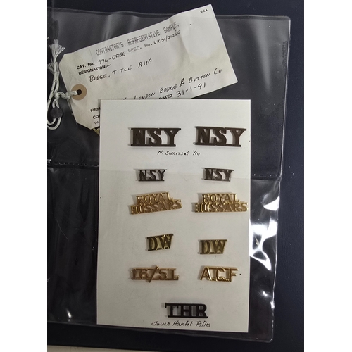 415 - Nineteen London Badge & Button Co. Contractor's Samples for mostly Naval badges, titles and fitt... 