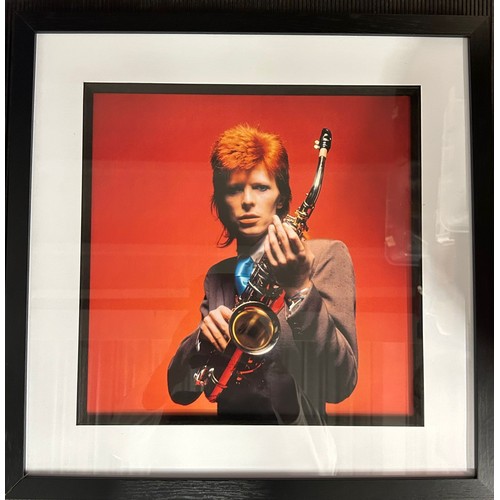 373 - 3 pictures; David Bowie portrait holding Sax red, London 1973 17
