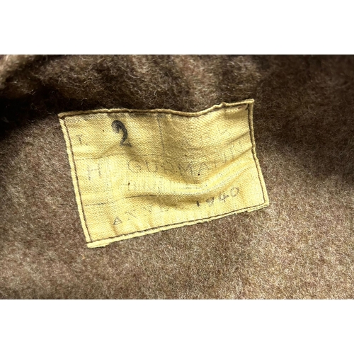 407 - A Belgian military style brown leather jerkin lined with khaki cloth, label of ‘H. Gurmann, Bruxelle... 