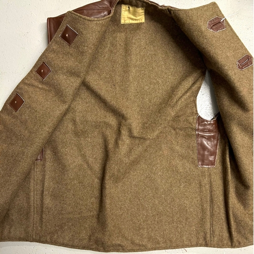 407 - A Belgian military style brown leather jerkin lined with khaki cloth, label of ‘H. Gurmann, Bruxelle... 