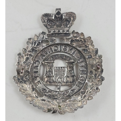 411 - The Suffolk Regiment. An officer’s Foreign Service helmet badge in plated white metal, crowned oak s... 