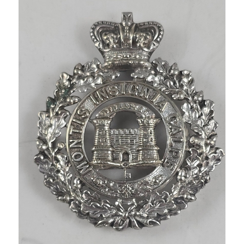 411 - The Suffolk Regiment. An officer’s Foreign Service helmet badge in plated white metal, crowned oak s... 