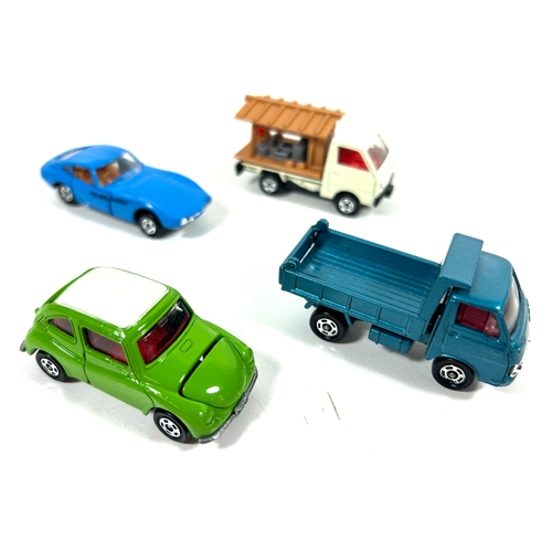 44 - 4 various scale Tomica. No.5 Toyota 2000GT. No.21 Subaru 360. No.35 Isuzu Elf Pick-Up. Plus a No.45 ... 