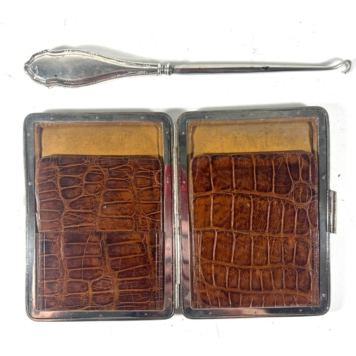 27 - A Victorian crocodile leather card case with silver corner mounts and metal frame, embossed with own... 