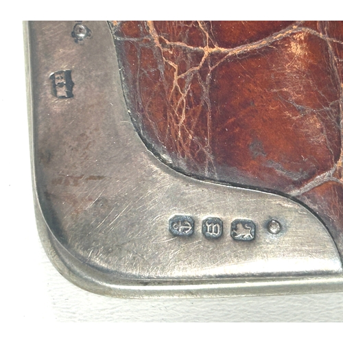 27 - A Victorian crocodile leather card case with silver corner mounts and metal frame, embossed with own... 