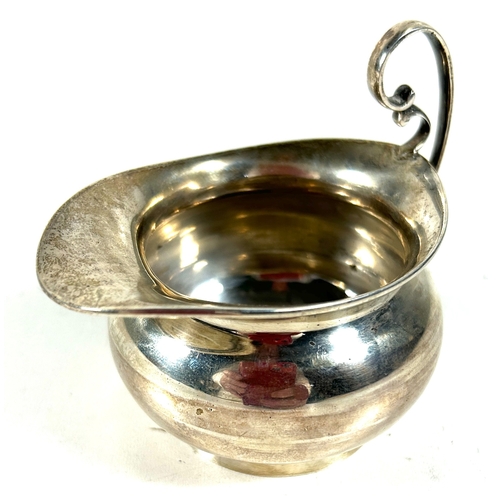 28 - A small silver creamer/ milk jug. B'ham 1906, by T.W. Weight 58gms