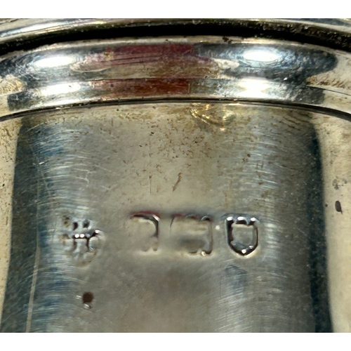 30 - Two silver peppers on pedestal feet. London 1910, marks rubbed. Weight 84gms.