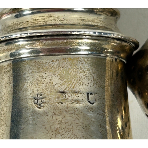 30 - Two silver peppers on pedestal feet. London 1910, marks rubbed. Weight 84gms.