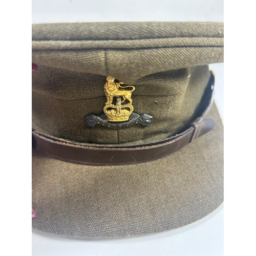 57 - British Army officers peaked cap badged to the Royal Army pay corps. Also a WW2 steel helmet with tr... 