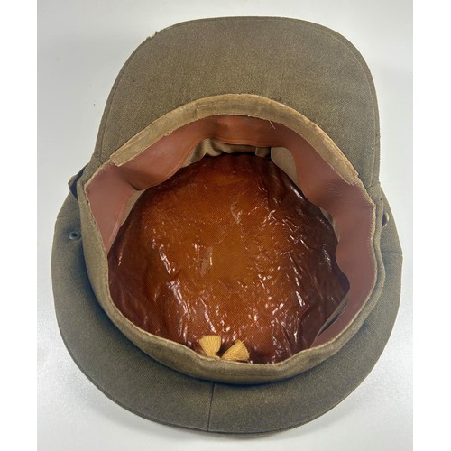 57 - British Army officers peaked cap badged to the Royal Army pay corps. Also a WW2 steel helmet with tr... 