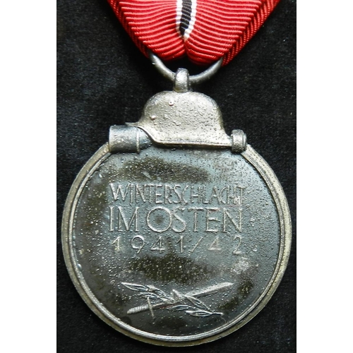 14 - WW II Eastern Front Medal. Suspension ring marked ‘23’ Made by Arbeitsgemeinschaft fur Heresbedarf i... 