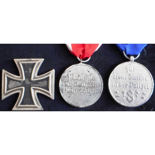 26 - (3) WW II Iron Cross 2nd class. Broken suspender.; Medal for Social Welfare.; Cast reproduction of 8... 