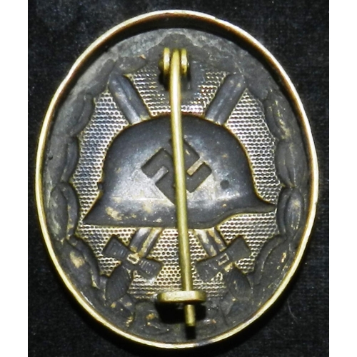 33 - WW II Wound badge in black, which is mostly worn off. Stamped brass, 0.5oz. Probably early war.