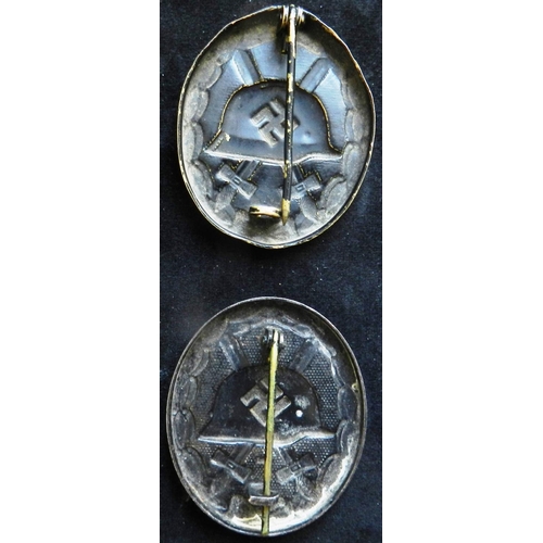 39 - (2) WW II Wound badge in black. Stamped brass. Another stamped steel. Both with some wear, both 0.4o... 