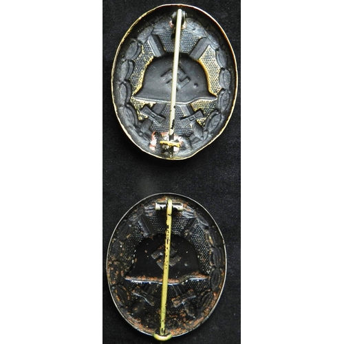 44 - (2) WW II Wound badge in black. Stamped brass. Another stamped steel. Both with some wear, both 0.3o... 