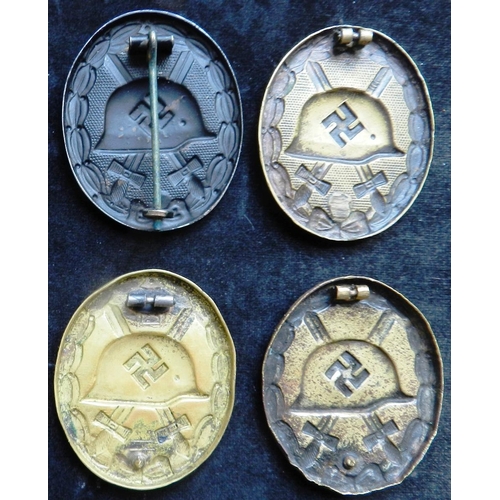 49 - (4) WW II Wound badge in black. Stamped steel. Some slight wear. 3 others in stamped brass, with def... 