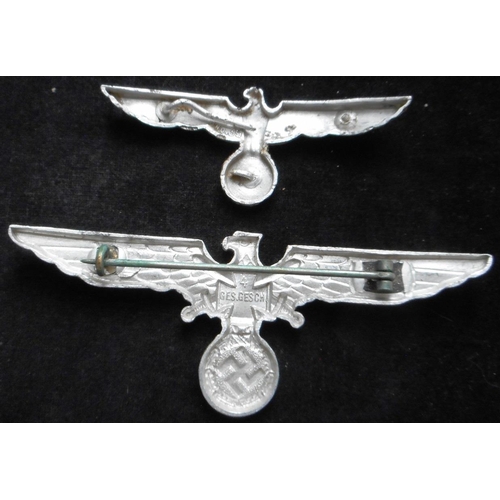 87 - (2) WW II NS-RKB metal chest eagle. (Krieger Bund). Also a metal cap eagle, defective prongs.