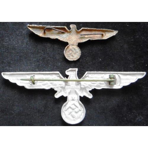 89 - (2) WW II NS-RKB metal chest eagle. (Krieger Bund). Also a metal cap eagle in excavated condition.