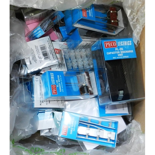 103 - 2 boxes of Peco-Lectrics fittimgs, bridges, other spares etc. Also quantity of track.