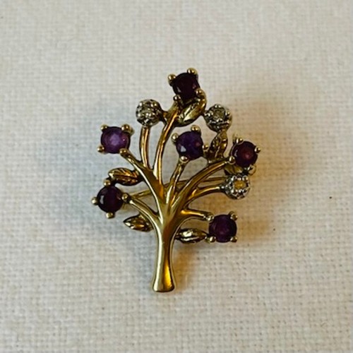 56 - Two Small 9ct Gold Brooches in a leaf form
One ruby set, one diamond and purple sapphire set
4.1g co... 