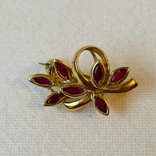 56 - Two Small 9ct Gold Brooches in a leaf form
One ruby set, one diamond and purple sapphire set
4.1g co... 